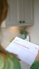 Close Up Of Woman Opening Letter About Increase in Mortgage Rate During Cost Of Living Crisis