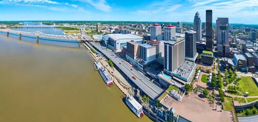Panorama Ohio River waterway riverboats and bridges leading to heart of downtown Louisville KY