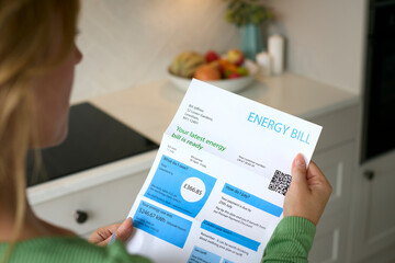 Close Up Of Woman Opening UK Energy Bill During Cost Of Living Crisis