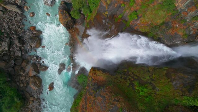 Aerial top down view beautiful Waterfall in Chyamche village, surrounded by green himalayan hills - Annapurna Circuit trek in Nepal. Way to Manang. Himalayas trekking and travels.
