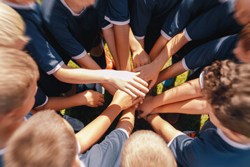 Many Happy Children Stacking Their Hands In A Teamwork Effort Before Playing Sports Game. Junior...