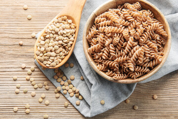 Green lentil fusilli pasta on a old wooden background.