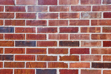 Background asset red brick wall with varying hues and white mortar