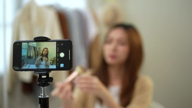 Screen smartphone attractive young influencer woman share makeup tutorials on social media. Beauty blogger sells cosmetics shopping online. Makeup artist blogger teaching on social media.