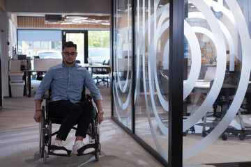 Fototapeta na wymiar In a large modern corporation, a determined businessman in a wheelchair navigates through a hallway, embodying empowerment and inclusivity in the corporate world.