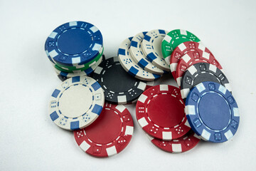 different color poker chips isolated on white gray background