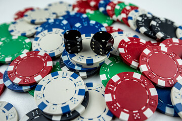 Two black dice on poker chips, top view. Casino concept