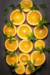 Slices of orange and mint on a gray background