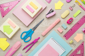 Flat lay with colorful school stationery on wooden backgroung, top view