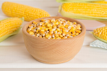 Dry corn with fresh cobs on wooden table