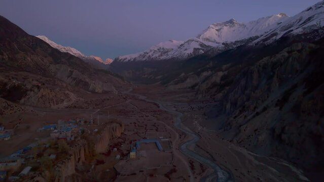 Aerial cinematic panoramic birds eye view valley with river stream and manang village houses. Manang district. Tilicho base camp trail. Himalayas mountains and trekking concept.