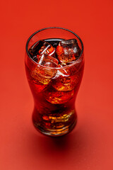 Refreshing glass of cola with ice