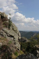 Vertical view from the Bruchhauser Steine near Olsberg, Sauerland, Germany. The big stone is part of a series of rocks on a mountain in a rolling hills landscape.
