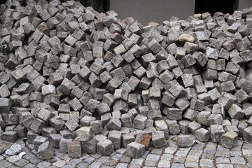 Pile of cobblestones on a pavement, a construction background