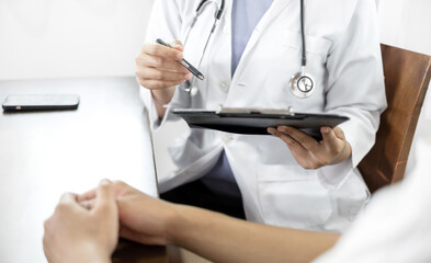 Female doctors who treat patients make an appointment to listen to the results after a physical examination and explain medical information and diagnose the disease. Medical concepts and good health