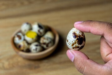 quail eggs in wooden bowl.