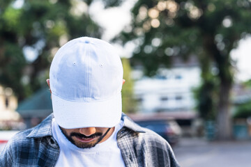 Discover the perfect blend of youthfulness and elegance in this captivating mockup image, featuring a young man wearing a white blank hat