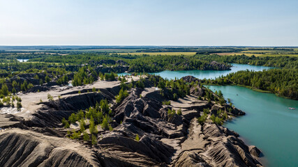 panoramic view of the high hills of the lake with turquoise water and green forest from the reserve in the Tula region taken from a drone