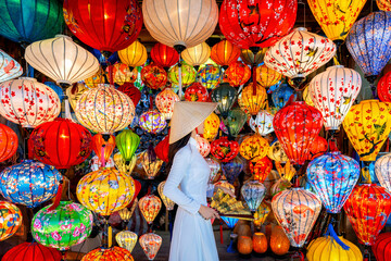 Asian woman wearing vietnam culture traditional and hoi an lanterns at Hoi An ancient town, Vietnam. - obrazy, fototapety, plakaty
