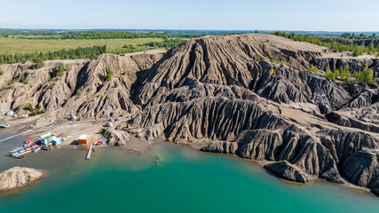 panoramic view of the high hills of the lake with turquoise water and green forest from the reserve in the Tula region taken from a drone