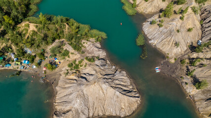 panoramic view of the high hills of the lake with turquoise water and green forest from the reserve in the Tula region taken from a drone