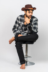 Embrace the art of poise as a young man effortlessly executes a simple pose in a captivating indoor setting