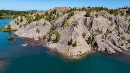panoramic view of the high hills of the lake with turquoise water and green forest from the reserve in the Tula region taken from a drone
