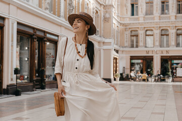 attractive woman walking in shopping street in Italy on vacation dressed in white summer fashion...