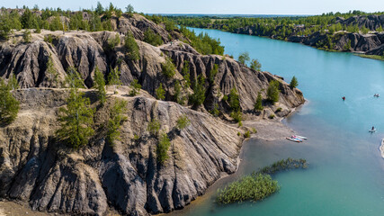 panoramic view of the high hills of the lake with turquoise water and green forest from the reserve in the Tula region taken from a drone