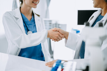 Fototapeta na wymiar Doctor, handshake and partnership in healthcare, medicine or trust for collaboration, unity or support.Team of medical experts shaking hands in teamwork for or success in clinic or hospital
