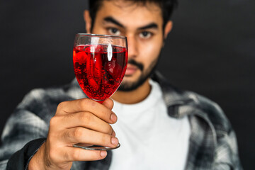 Discover the artistry of wine appreciation as a young man showcases his drink with poise