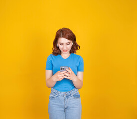 Girl holding cell phone, close up portrait of nice attractive red-haired girl holding cell phone....