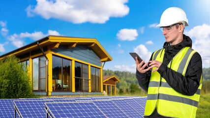 Solar power plant engineer. Man near photovoltaic generators. Solar panels for country house. Man...