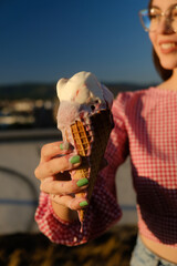 woman holding melting ice cream cone