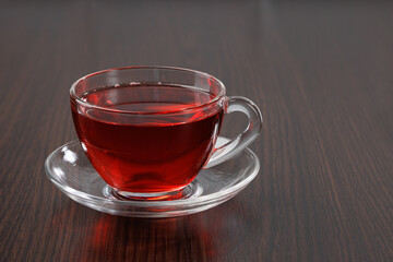 Glass cup with hot tea on the background of the table. Angle view. Place for text, copy space.