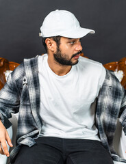 Effortlessly chic, the mockup image showcases a young man's understated style with a white blank...