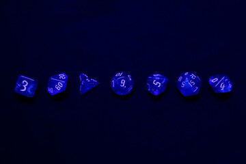 blue colour dices for fantasy dnd and rpg tabletop games. Board game polyhedral dices with different sides isolated on black background