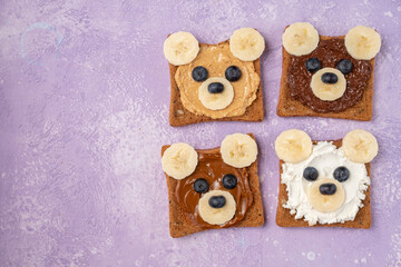 Breakfast toasts with nut butter and banana with cute funny bear face