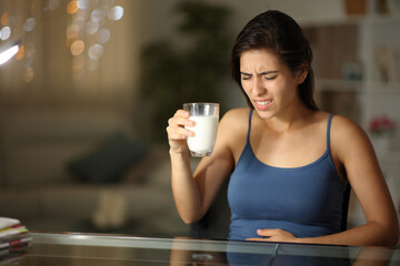 Woman suffering lactose intolerance after drinking milk - obrazy, fototapety, plakaty