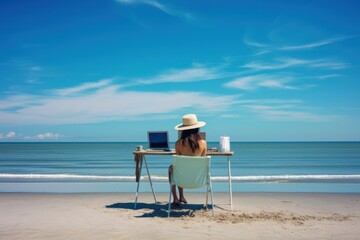 Fototapeta na wymiar girl working on a computer on the beach 