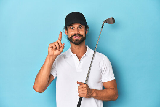 Long-haired golfer with club and hat having an idea, inspiration concept.