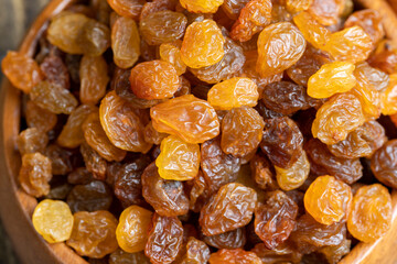 Dried yellow golden raisins on a board