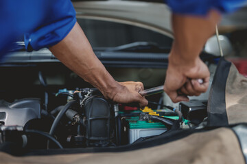 Fototapeta na wymiar Professional mechanic checking and repairing a car. Auto mechanic working in garage. Repair service.