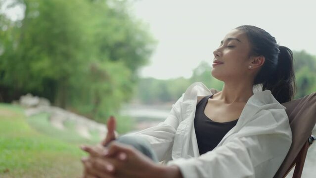 Beauty concept of young asian woman, Happy relaxation woman sitting and having relax and happy smile at nature outdoor green park for mental therapist for Leisure cheerful wellness