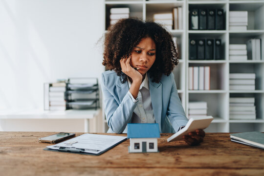 young women asia sad lady people sit sofa couch at home think hard worry in tax expense saving issue past due loan late payment on covid impact life feel grief pensive housing debt concepts.