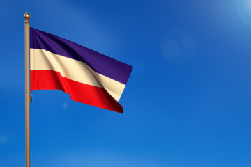 Los Altos. Flag blown by the wind with blue sky in the background.