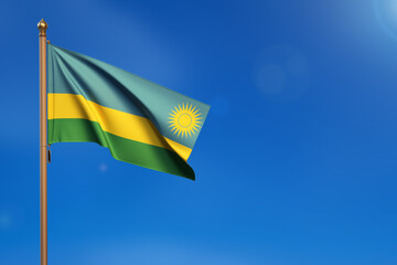 Rawanda. Flag blown by the wind with blue sky in the background.