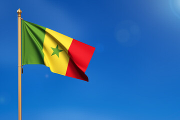 Senegal. Flag blown by the wind with blue sky in the background.