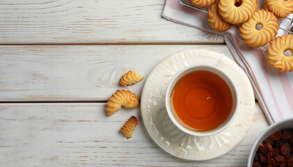 Delicious Danish butter cookies and tea on white wooden table, flat lay