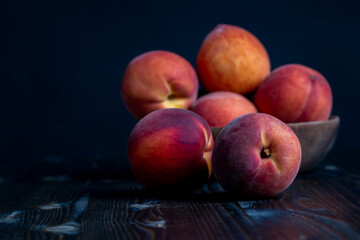 Ripe fresh peaches on a wooden table